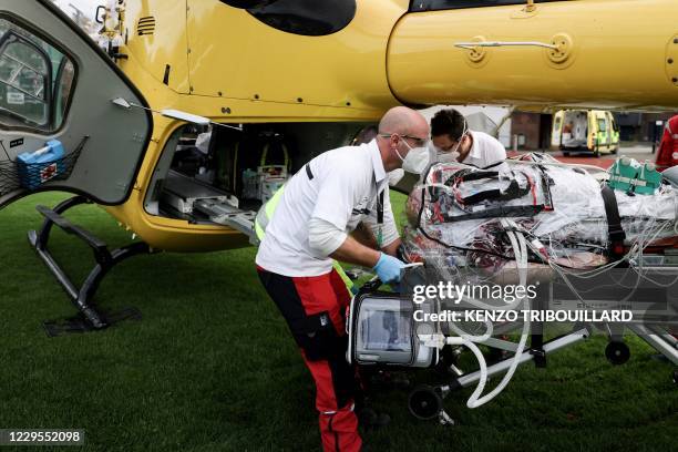 Medics ready to load a patient infected with Covid-19 into a waiting helicopter to be transfered from Verviers hospital in Verviers to Antwerp , on...