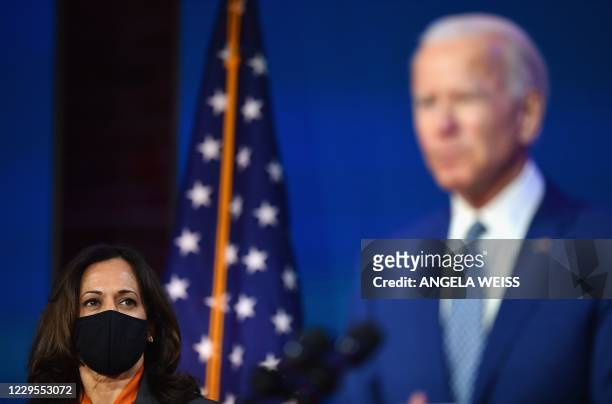 President-elect Joe Biden delivers remarks as US Vice President-elect Kamala Harris listens at The Queen in Wilmington, Delaware, on November 9,...