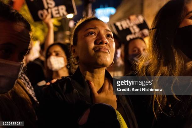 Angelique McKenna of Arlington, gets emotional listening to President-elect Joe Biden's speech, played over a loudspeaker at Black Lives Matter Plaza...