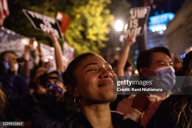 Angelique McKenna of Arlington, gets emotional listening to President-elect Joe Biden's speech, played over a loudspeaker at Black Lives Matter Plaza...