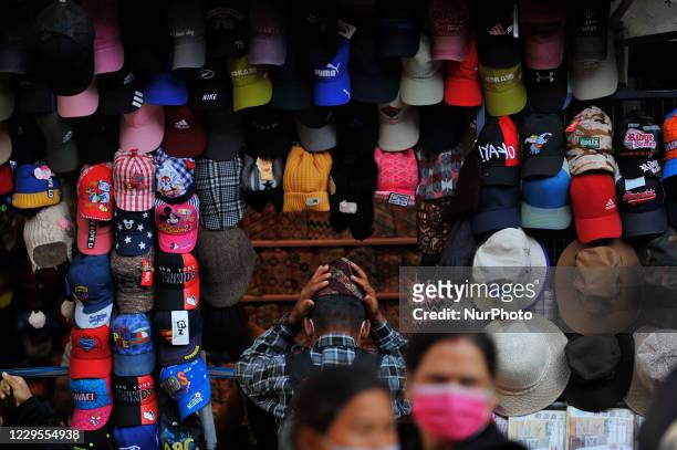 Nepalese people buys Dhaka Topi from the market at Ason, Kathmandu, Nepal on November 09, 2020.