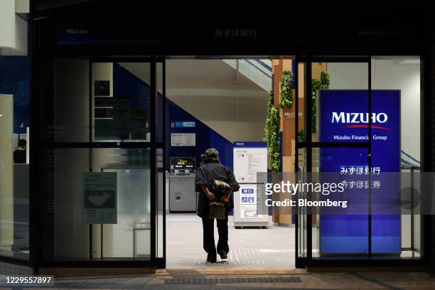 Customer enters a branch of Mizuho Bank Ltd. In Kawasaki, Kanagawa Prefecture, Japan, on Monday, Nov. 9, 2020. Japanese banks expect business...