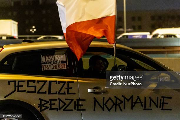 Women's rights activists and their supporters are seen in their cars marked with protest banners during a car protest of the third week of Women's...