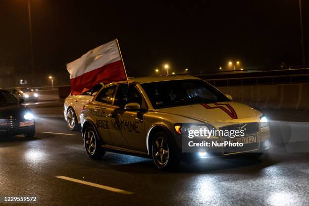 Women's rights activists and their supporters are seen in their cars marked with protest banners during a car protest of the third week of Women's...