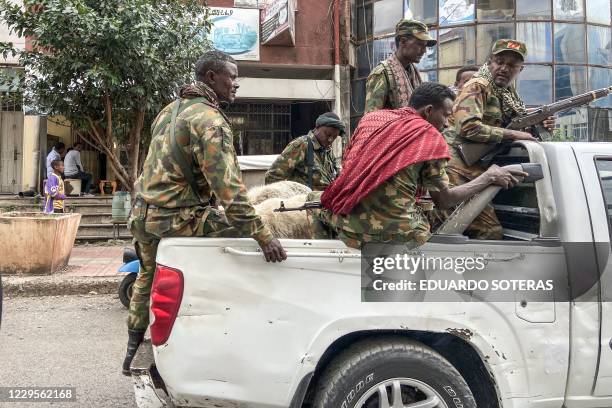 Members of the Amhara militia, that combat alongside federal and regional forces against northern region of Tigray, ride on the back of a pick up...