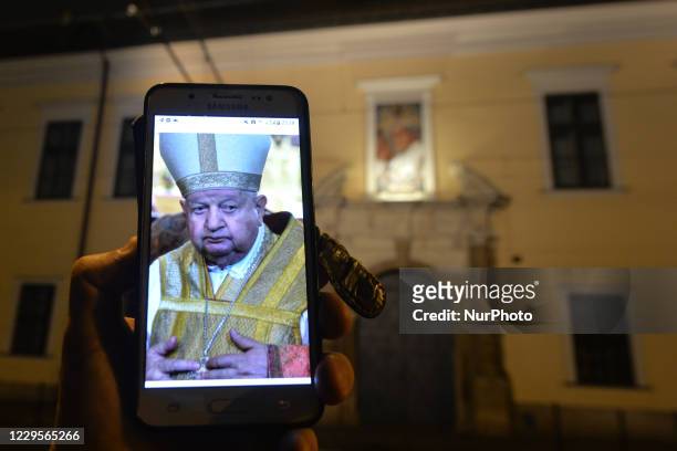 An illustrative photo with a portraitof Cardinal Stanislaw Dziwisz seen on a mobile phone, in front of Krakow Bishops Palace in Franciszkanska...