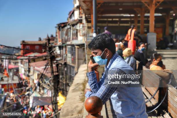 Man wearing a mask speaks on a cell phone amid COVID-19 Pandemic in Shimla, Himacal Pradesh, India on 07 November 2020. Himachal Pradesh is a...