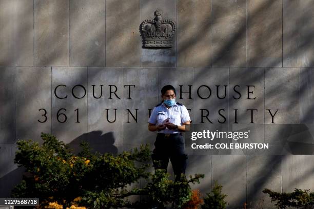 Security guard stands outside the Superior Court of Justice in Toronto, Ontario, Canada on November 10 during the first day of the trial for accused...