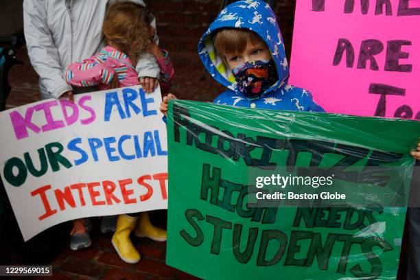 An Eliot School K2 student holds a sign during a rally outside of Boston City Hall in Boston called "Stand up for BPS Kids" demanding schools to...