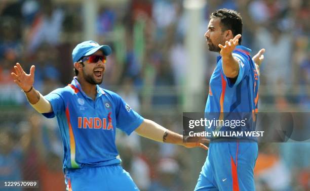 Indian fast bowler Zaheer Khan is congratulated by teammate Virat Kohli after dismissing Sri Lankan batsman Upul Tharanga during the ICC Cricket...
