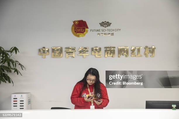 An employee stands behind the reception desk at a livestreaming base during Alibaba Group Holding Ltd.'s annual November 11 Singles' Day online...