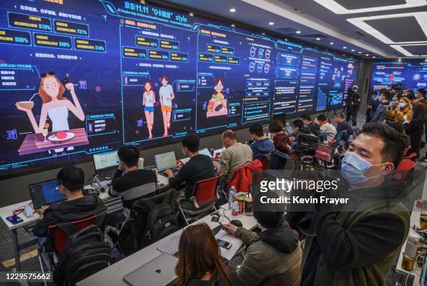Workers from Chinese e-commerce giant JD.com track sales and trends for Singles Day in the data center control room at the company's headquarters...