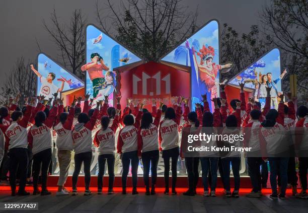 Workers from Chinese e-commerce giant JD.com have photos taken during a break for Singles Day at the company's headquarters during an organized tour...