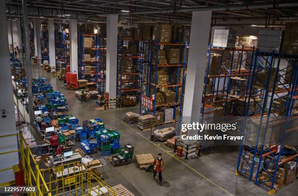 Workers from Chinese e-commerce giant JD.com work in the warehouse at the company's main logistics hub during an organized tour for Singles Day on...