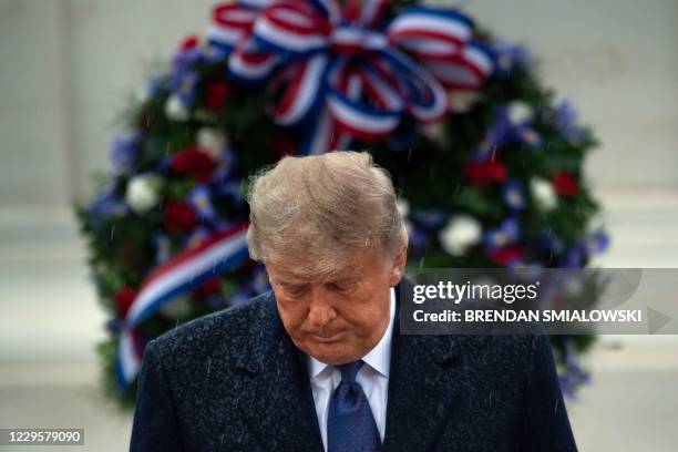 President Donald Trump leaves after placing a wreath at the Tomb of the Unknown Soldier on Veterans Day at Arlington National Cemetery in Arlington,...