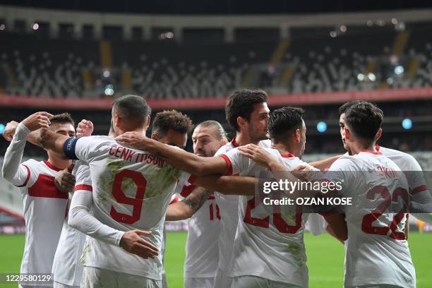 Turkey's forward Cenk Tosun celebrates with teammates after scoring on a penalty kick during the friendly football match between Turkey and Croatia...