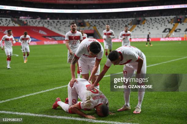 Turkey's forward Cenk Tosun celebrates past teammates after scoring on a penalty kick during the friendly football match between Turkey and Croatia...