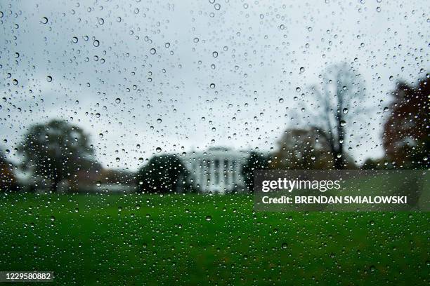 View of the White House during rain from a motorcade is seen on November 11 in Washington, DC. - US President Donald Trump and President-elect Joe...