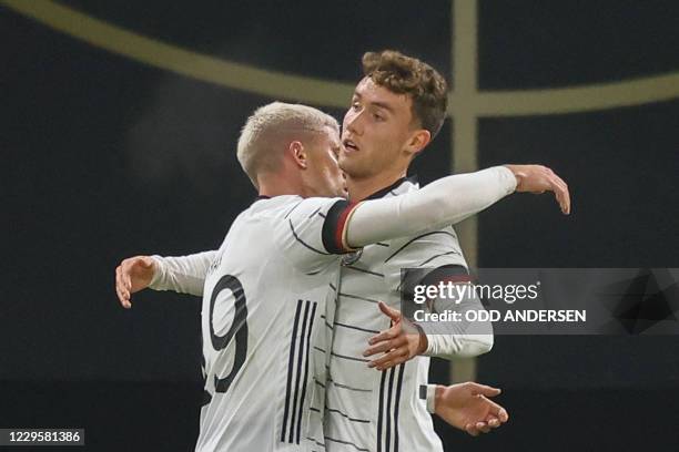 Germany's forward Luca Waldschmidt celebrates scoring the opening goal with his teammate Germany's defender Philipp Max during the international...