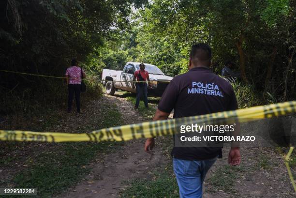 Members of the Ministerial Police cordon off the site where the body of the mayor of the Mexican municipality of Jamapa, Florisel Rios Delfin, was...
