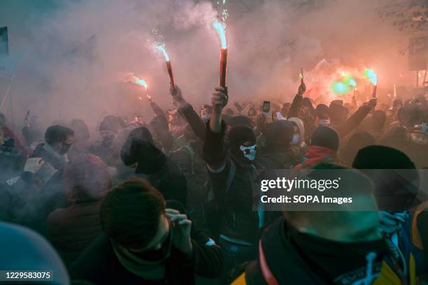 Masked nationalists burning flares during Independence Day. Thousands took part in an annual far-right march in Warsaw to mark Polands Independence...