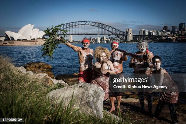 Nov. 11, 2020 -- Aboriginal people dance at Sydney harbour, Australia, Nov. 11, 2020. Australia on Sunday kicked off a week of celebrations...