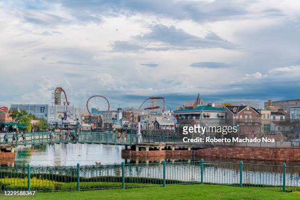 Urban skyline with rides seen across a lake in Universal Studios.