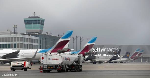 An aviation fuel truck passes Eurowings and Deutsche Lufthansa AG passenger aircraft on the tarmac at Munich Airport in Munich, Germany, on Thursday,...