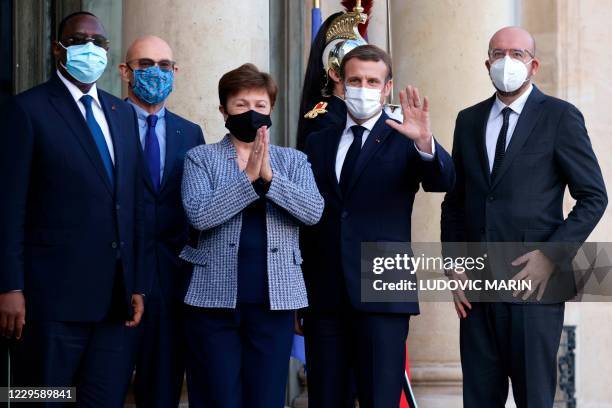 French President Emmanuel Macron welcomes Senegal's President Macky Sall , head of the Peace Forum Pascal Lamy , International Monetary Fund Managing...