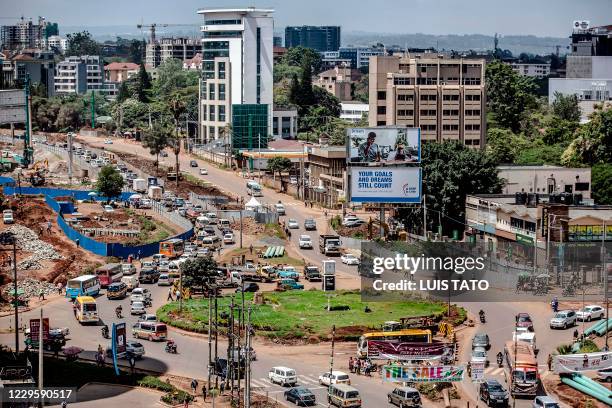 Traffic flows past the area where an iconic, century-old fig tree is placed after a presidential declaration was issued to save the centenary tree...