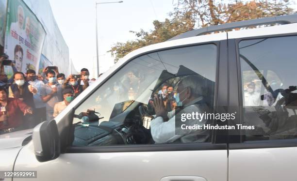 Bihar Chief Minister Nitish Kumar gestures at his supporters upon his arrival at the party headquarters, two days after the Bihar Assembly election...