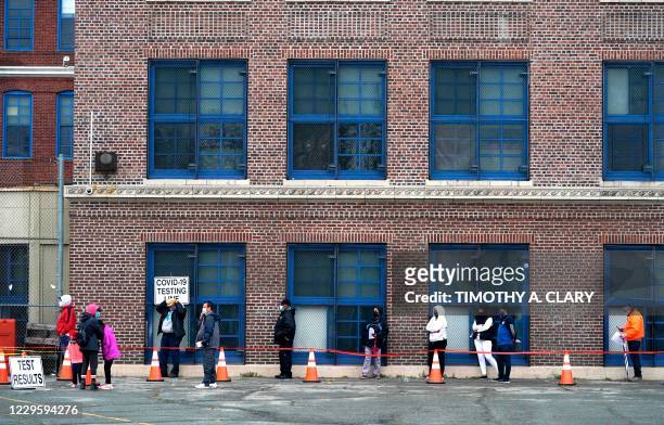 People wait in line to get tested for Covid-19 at the Ann Street School Covid-19 Testing Center in Newark, New Jersey on November 12, 2020. - US...