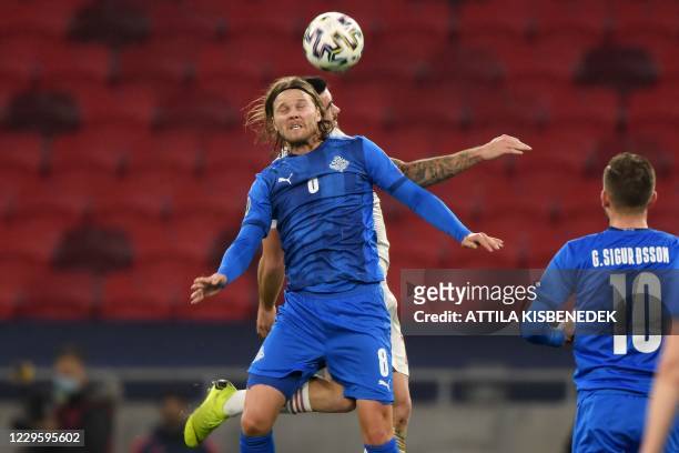 Hungary's defender Endre Botka and Iceland's midfielder Birkir Bjarnason vie for the ball during the UEFA European Qualifiers play-off final football...
