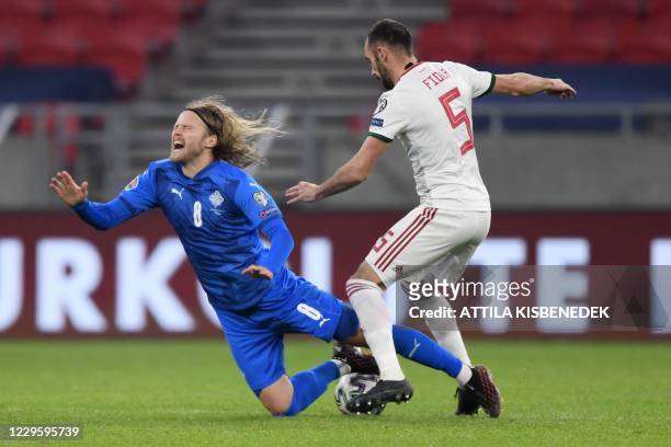 Iceland's midfielder Birkir Bjarnason is fouled by Hungary's defender Attila Fiola during the UEFA European Qualifiers play-off final football match...