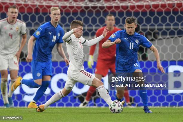 Iceland's Alfred Finnbogason and Hungary's midfielder David Siger vie for the ball during the UEFA European Qualifiers play-off final football match...
