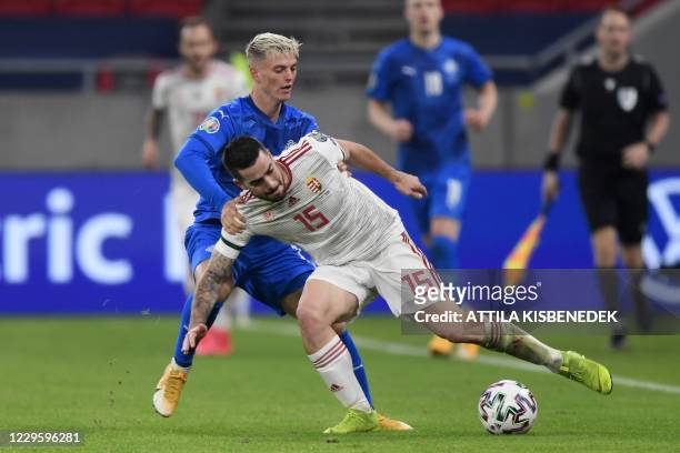 Hungary's defender Endre Botka vies for the ball with Iceland's forward Albert Gudmundsson during the UEFA European Qualifiers play-off final...