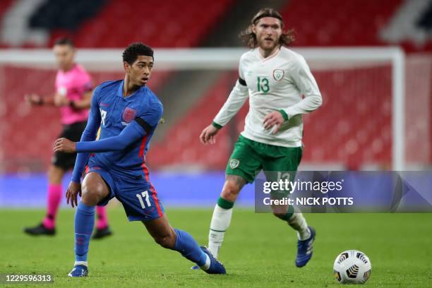 England's midfielder Jude Bellingham vies with Republic of Ireland's midfielder Jeff Hendrick during the international friendly football match...