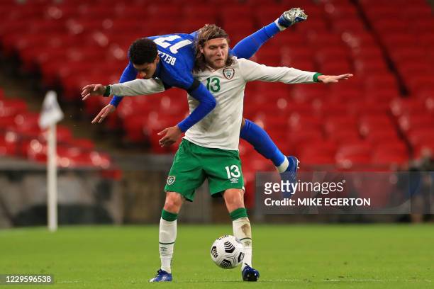 England's midfielder Jude Bellingham vies with Republic of Ireland's midfielder Jeff Hendrick during the international friendly football match...