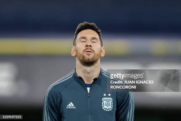 Argentina's Lionel Messi listens to the national anthem before the closed-door 2022 FIFA World Cup South American qualifier football match against...