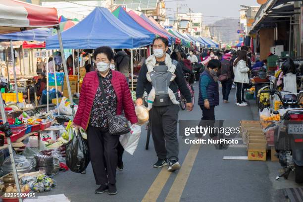 Visitors wear mask and shopping around traditional market place in Sangju, South Korea. South Korea's new coronavirus cases spiked to almost 200...