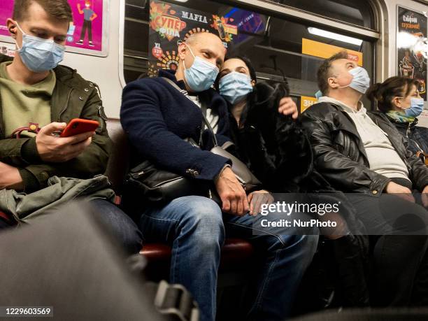 Passengers wear protective face masks inside a subway amid the outbreak of the coronavirus disease COVID-19 in Kyiv, Ukraine. November 2020