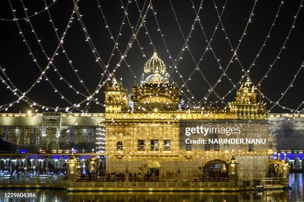 Sikh devotees pay respect on the eve of Bandi Chhor Divas, a Sikh festival coinciding with Diwali, the Hindu festival of light, at the illuminated...
