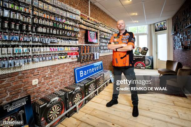 Raymond van Barneveld poses during the opening of his dart shop Barney's Darts and Trophies on November 13, 2020. - The darter said goodbye to the...