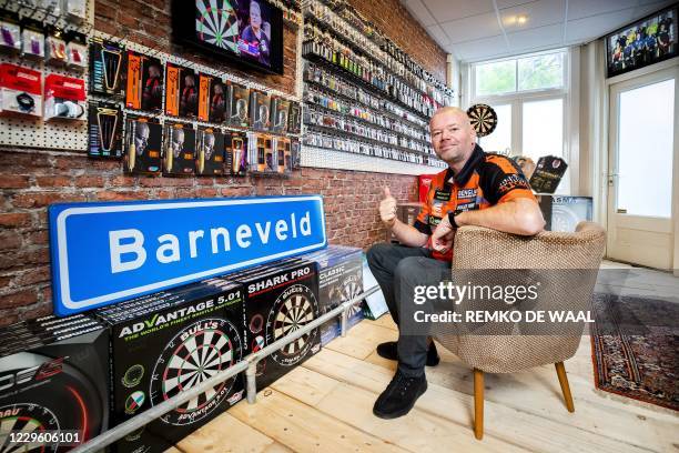 Raymond van Barneveld poses during the opening of his dart shop Barney's Darts and Trophies on November 13, 2020. - The darter said goodbye to the...
