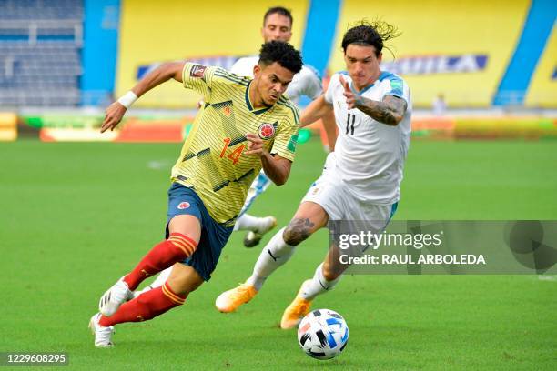 Colombia's Luis Diaz is challenged by Uruguay's Darwin Nunez during their closed-door 2022 FIFA World Cup South American qualifier football match at...