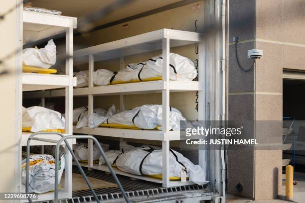 Graphic content / Bodies wrapped in plastic line the walls inside a refrigerated trailer used as a mobile morgue by the El Paso County Medical...
