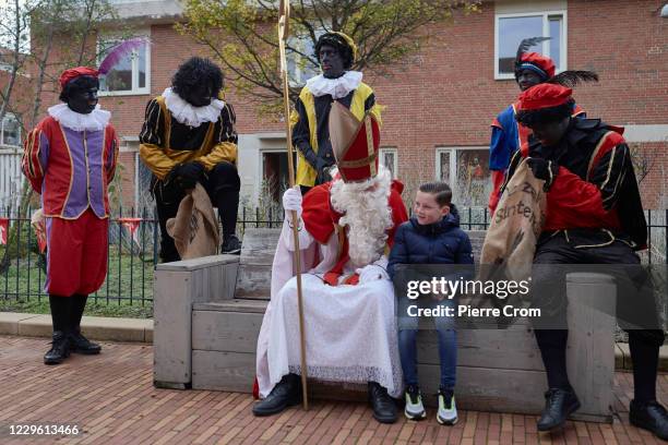 People dressed as Saint Nicholas and Black Pete are seen on the street during celebrations of the traditional arrival of Saint Nicholas on November...