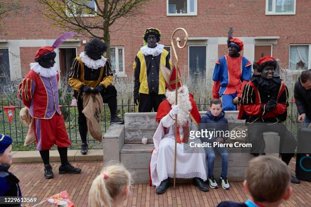 People dressed as Saint Nicholas and Black Pete are seen on the street during celebrations of the traditional arrival of Saint Nicholas on November...