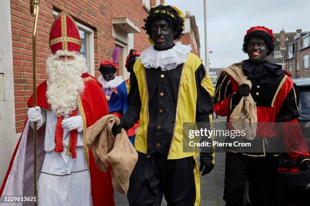 People dressed as Saint Nicholas and Black Pete are seen on the street during celebrations of the traditional arrival of Saint Nicholas on November...