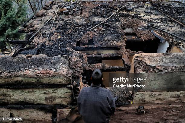 Man looks towards his damaged house due to cross border shelling in Hajipir area of Uri sector, Baramulla, Jammu and Kashmir, India on 14 November...